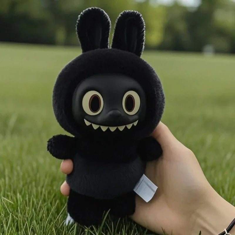 An authentic all-black POP MART Labubu vinyl plush keychain figure showing the signature toothy grin, soft black fur, and hanging loop