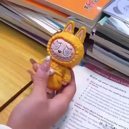 Labubu-style keychain with changeable faces, plush bag charm in yellow