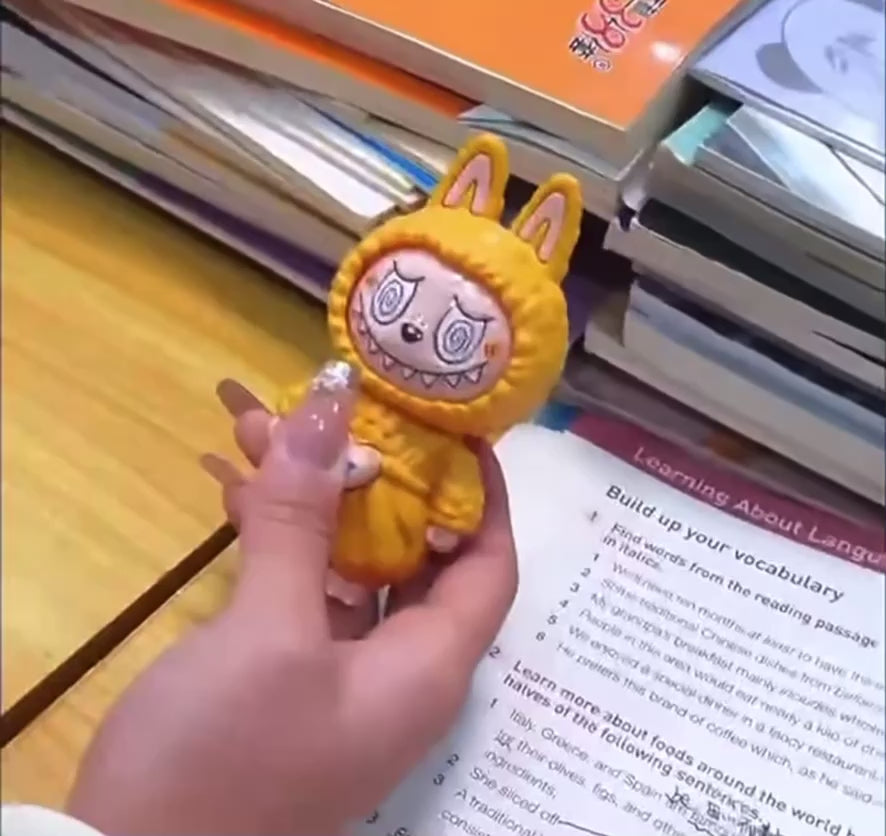 Labubu-style keychain with changeable faces, plush bag charm in yellow